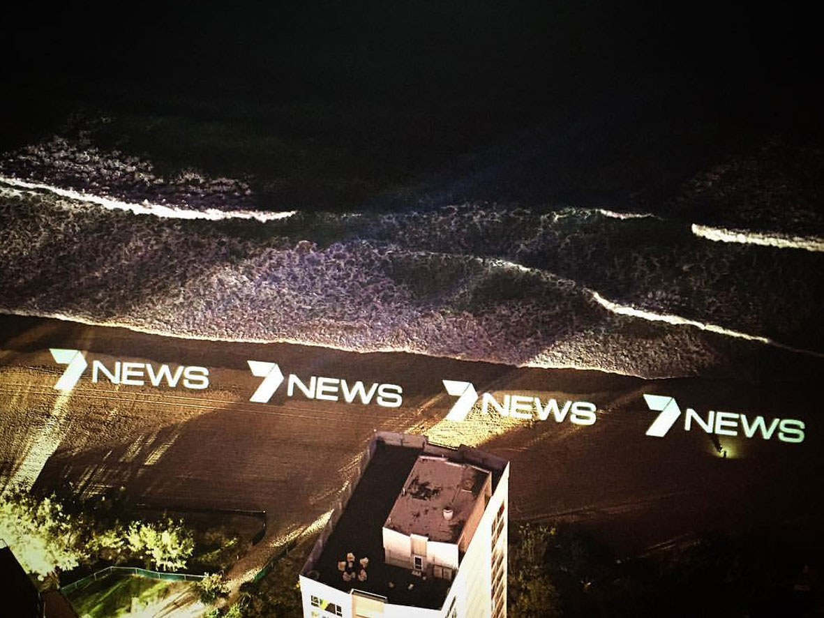 7 news logo projected onto surfers paradise beach from the top of q1 building